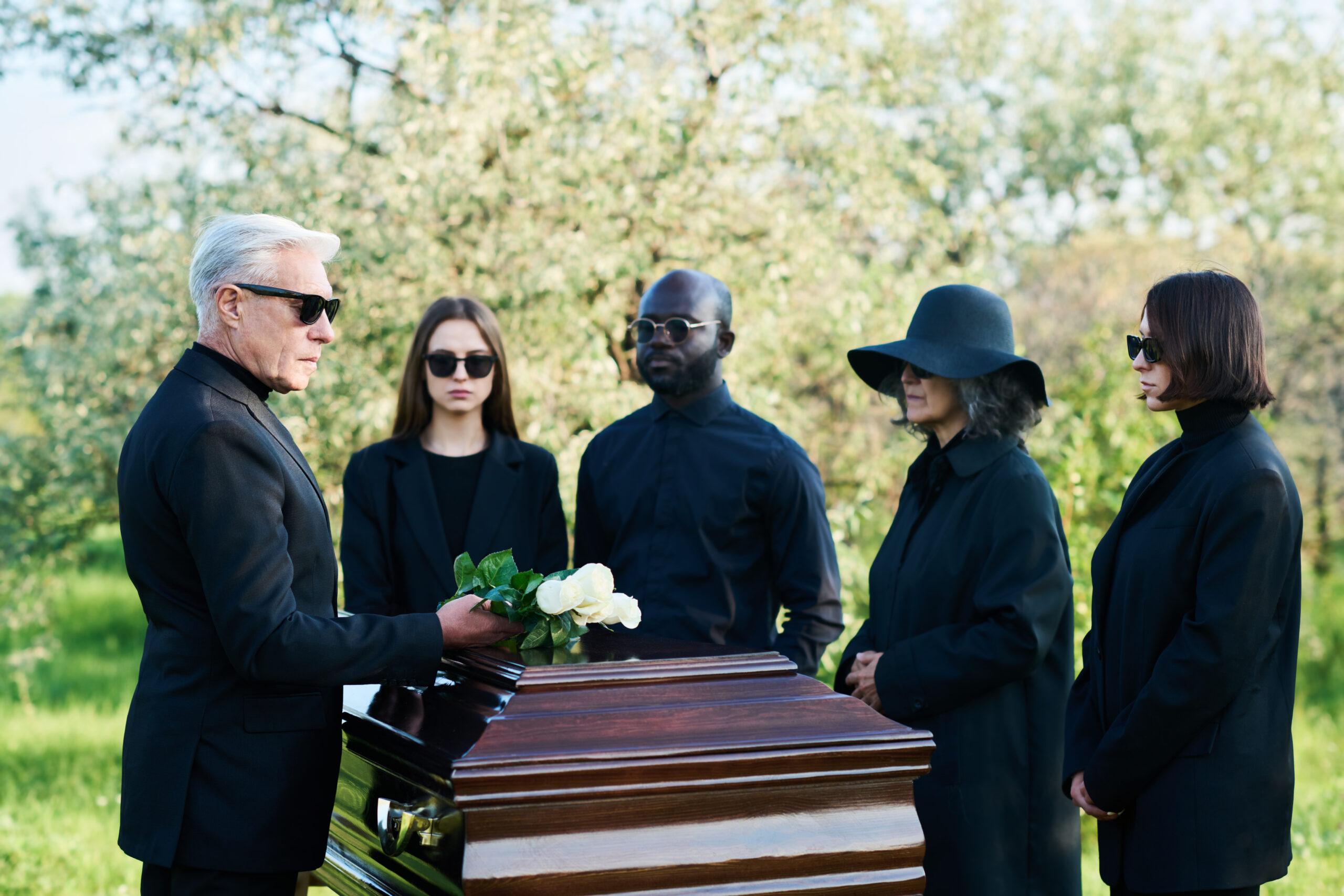 mourners gathered around a casket at a funeral 2026 03 09 03 22 35 utc
