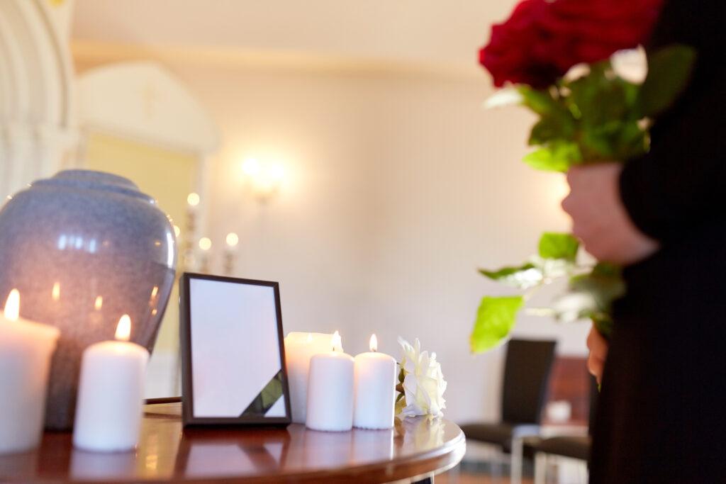 cremation urn and woman at funeral in church 2026 03 09 08 00 08 utc